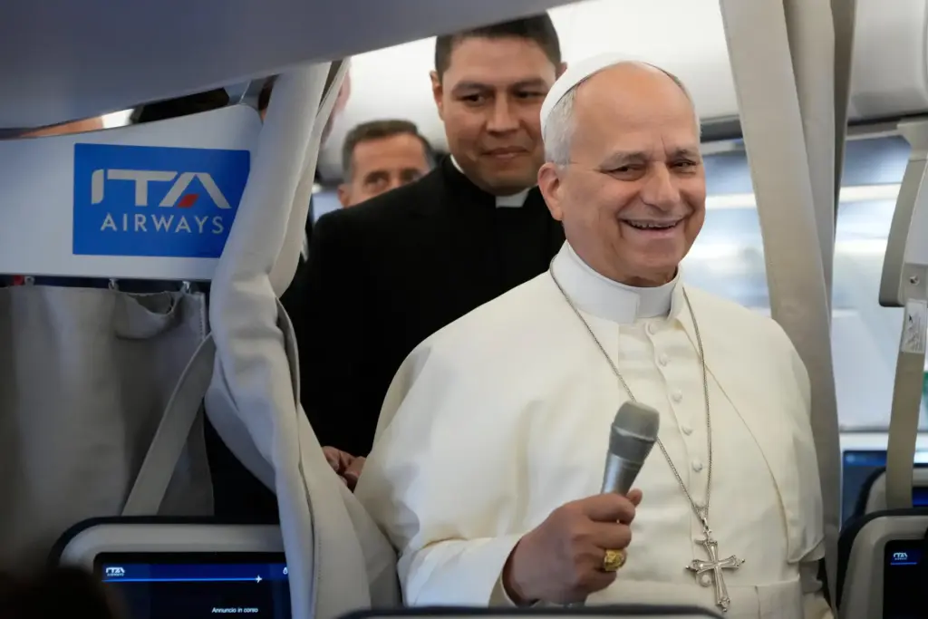 Pope Leo XIV talks to journalists aboard the papal flight from Rome to Paris.