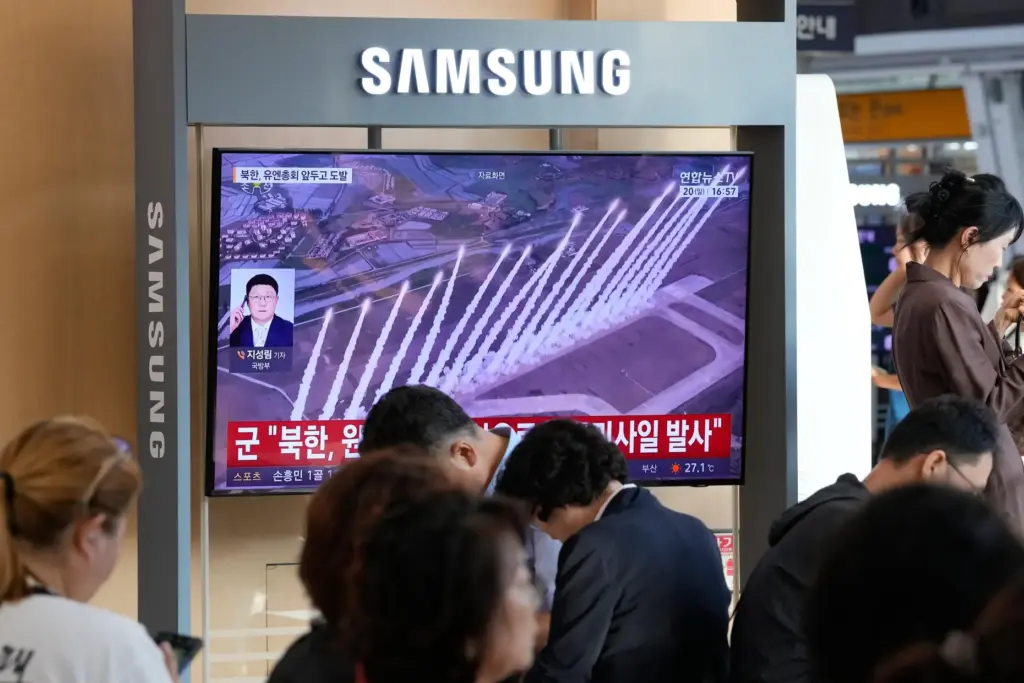 A TV screen shows a file image of a North Korean missile launch.