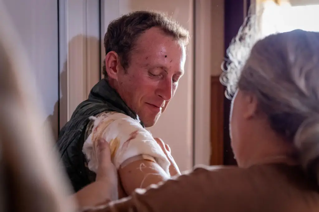 A woman bandages a man after a Russian missile strike in Kyiv, Ukraine.