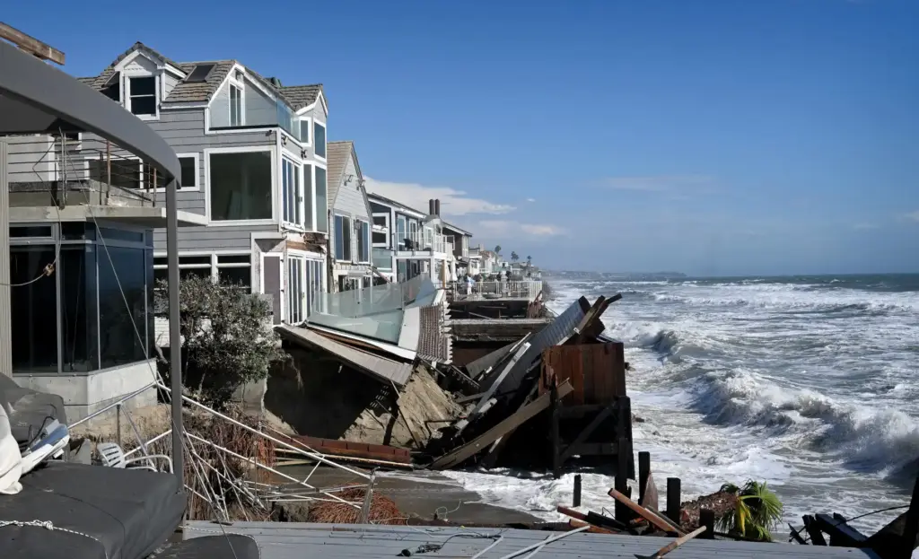 Waves crash into a home that was red tagged after...
