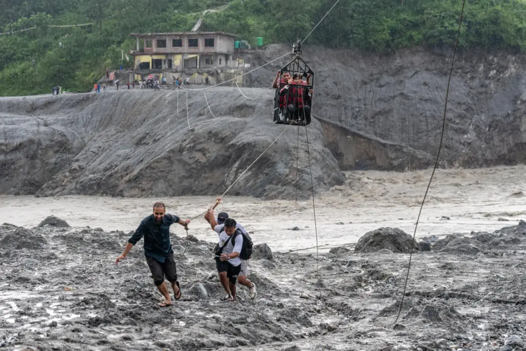 Residents pull a newly installed zipline to help people commute across the Trishuli River.