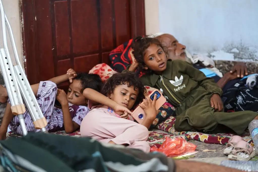 Displaced Yemenis rest at a temporary shelter in the Dar Saad district.