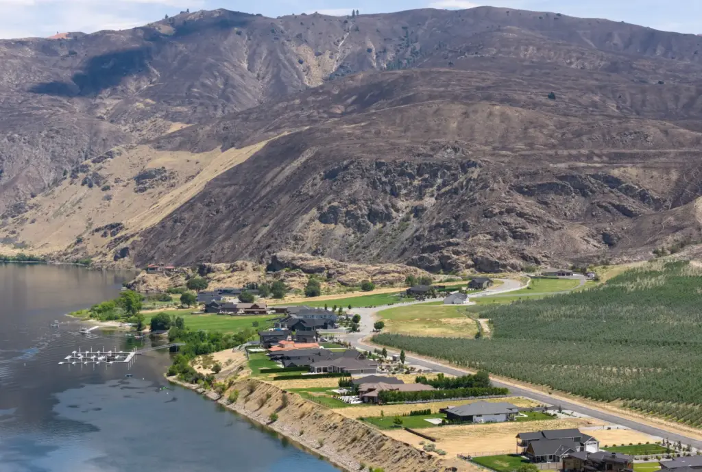 Charred earth from the Chelan Hills fire is seen beyond...