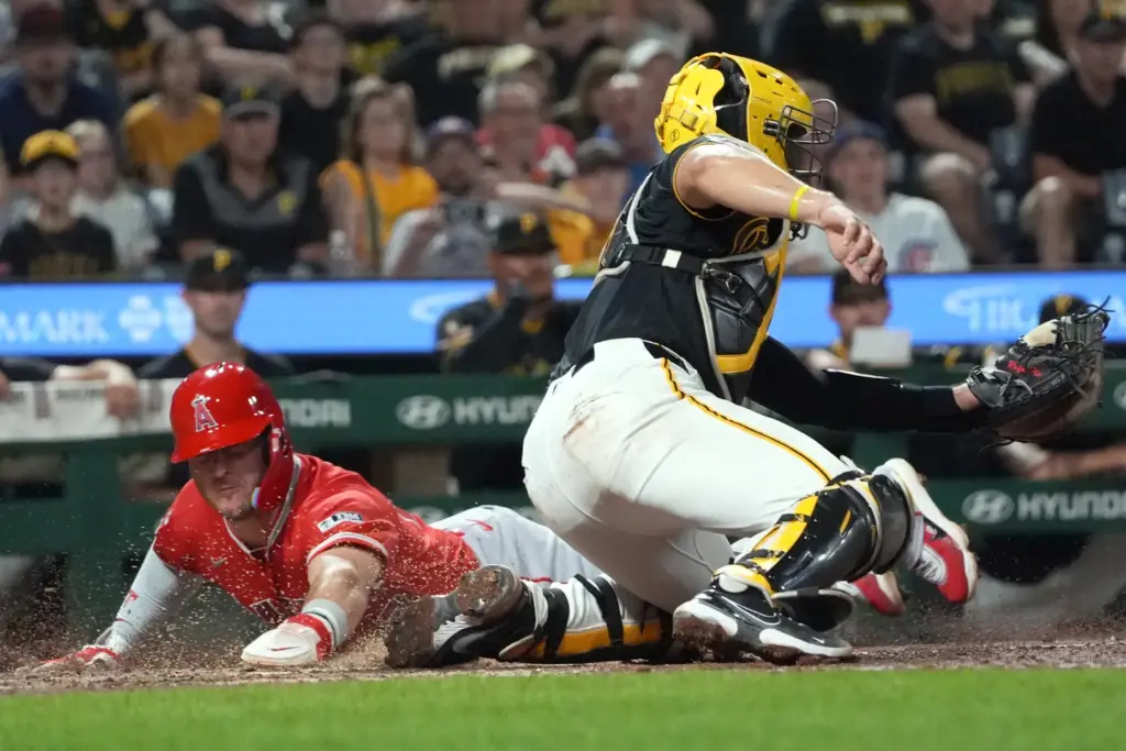 Angels’ Mike Trout, left, slides past Pittsburgh Pirates catcher Rafael...