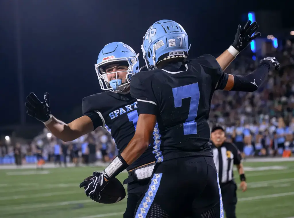 Villa Park wide receiver Ben Hannah, left, celebrates with wide...