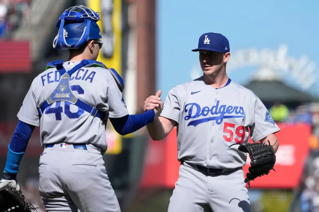 Dodgers pitcher Evan Phillips (59) is congratulated by catcher Hunter...