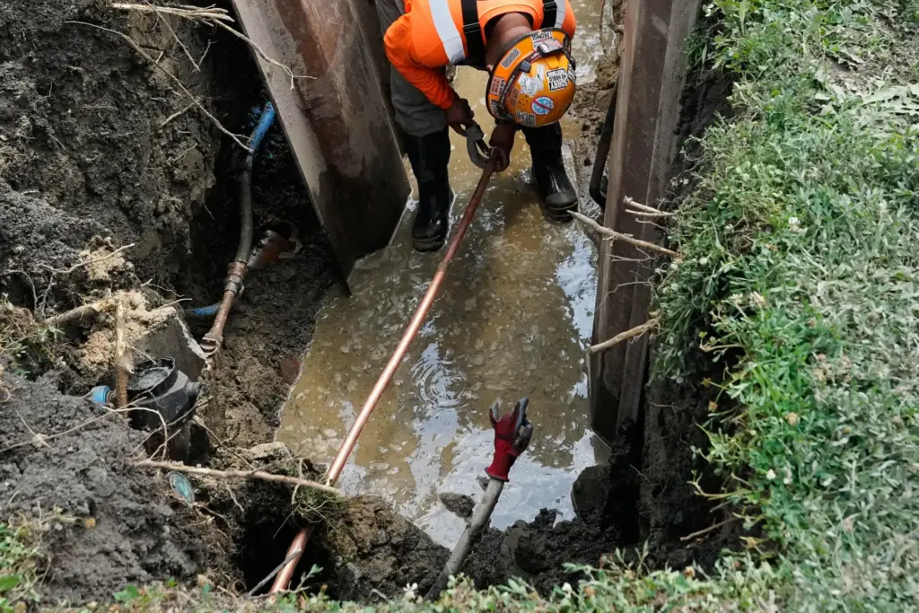 A lead pipe, bottom, is visible as a worker installs...
