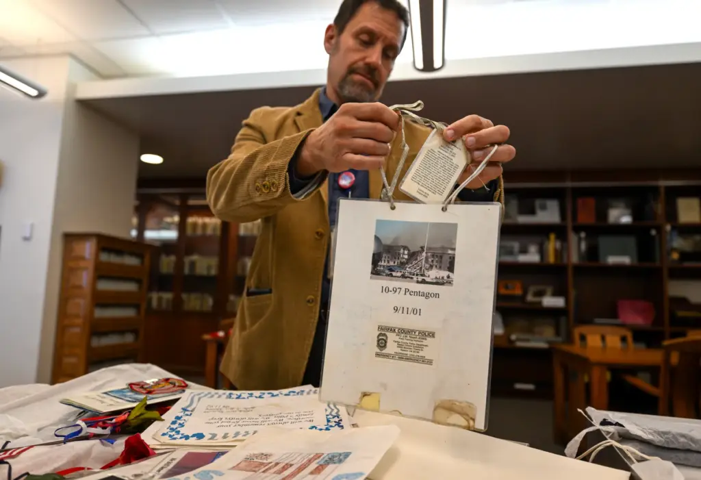 Professor David G. Schwartz looks over artifacts that were part...