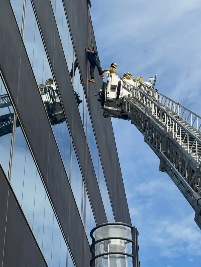 Firefighters rescued a window washer who was stranded about 60...