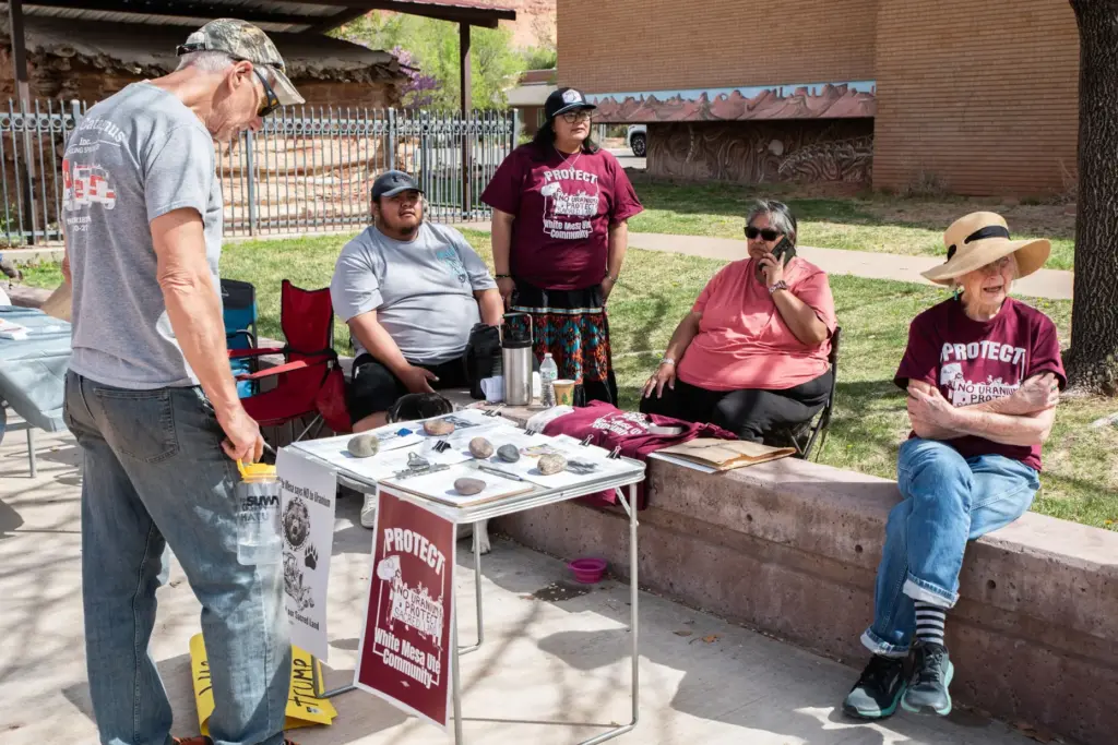 Yolanda Badback and Sarah Fields run an information table about White Mesa Mill.