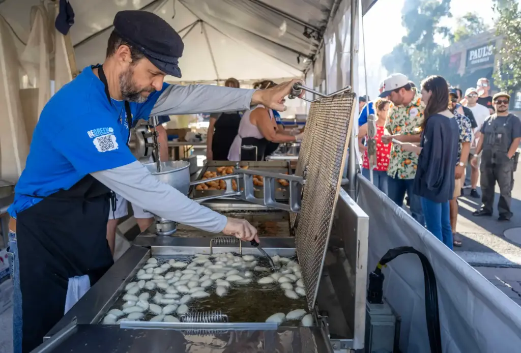 Greg Georgantas makes traditional loukoumades in the Greek section of...
