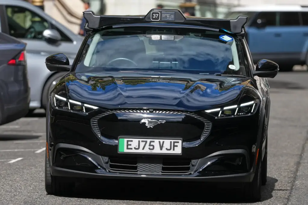 An autonomous car drives through the streets in Westminster, London,...