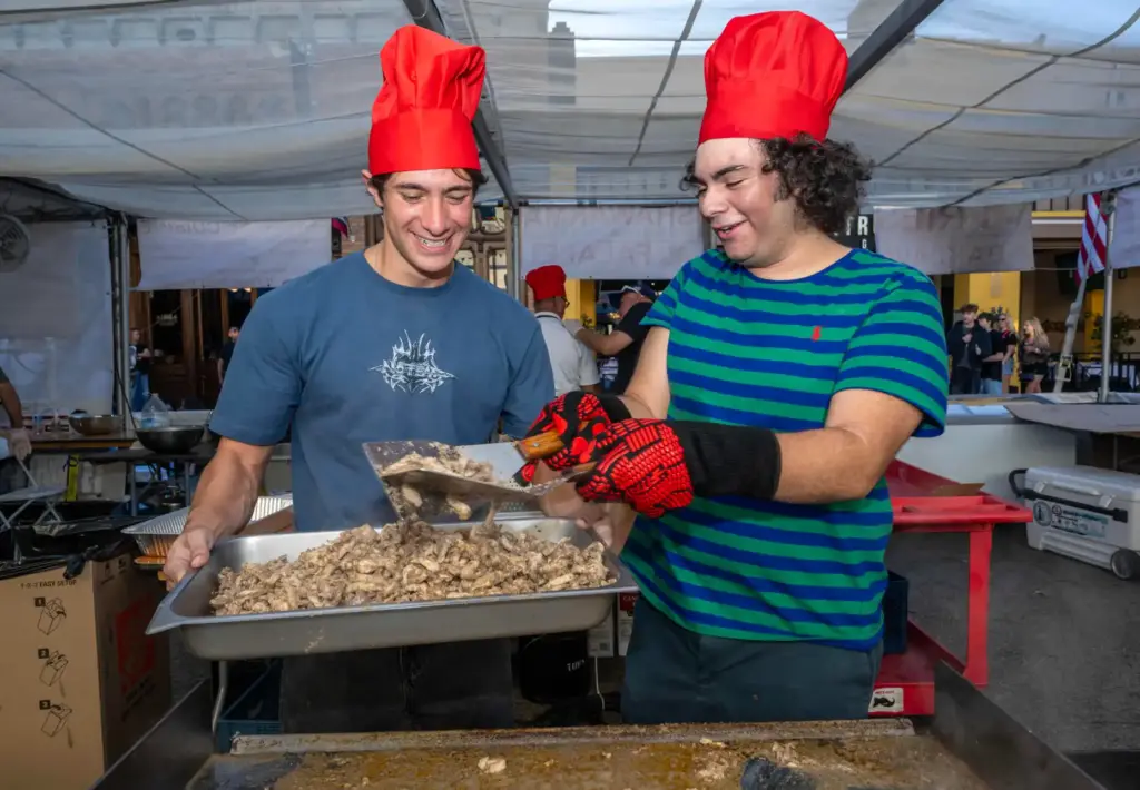 Anthony Karaf, left, and Christian Younes make chicken swarm in...