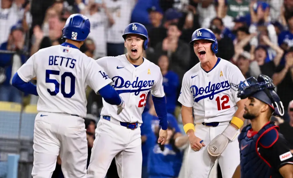 Dodgers shortstop Mookie Betts (50) celebrates with teammates Tommy Edman...