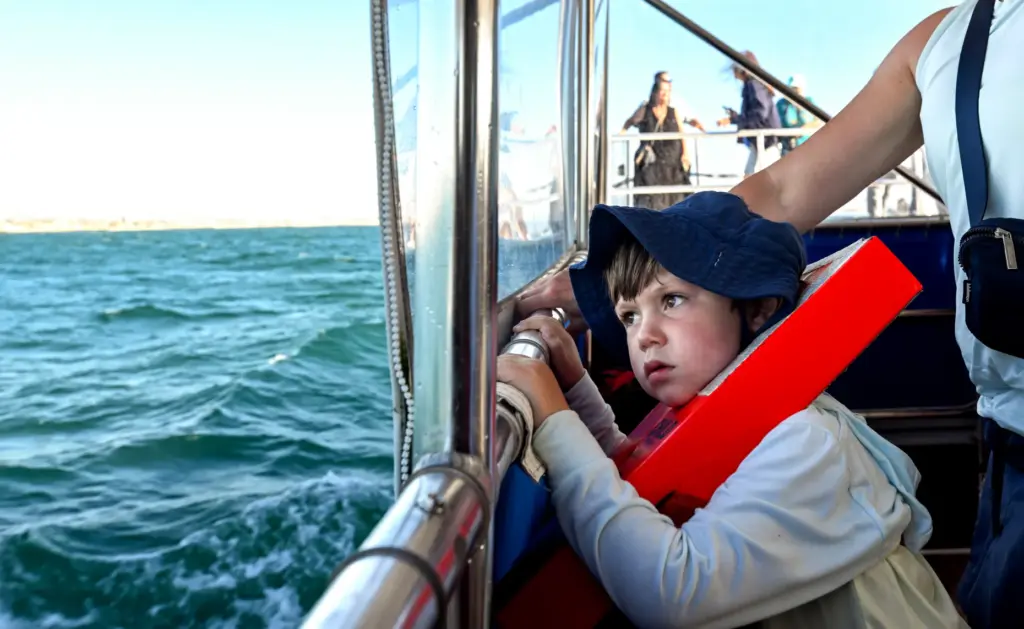 Ryder Demoe, 4, looks for Orcas in the waters off...