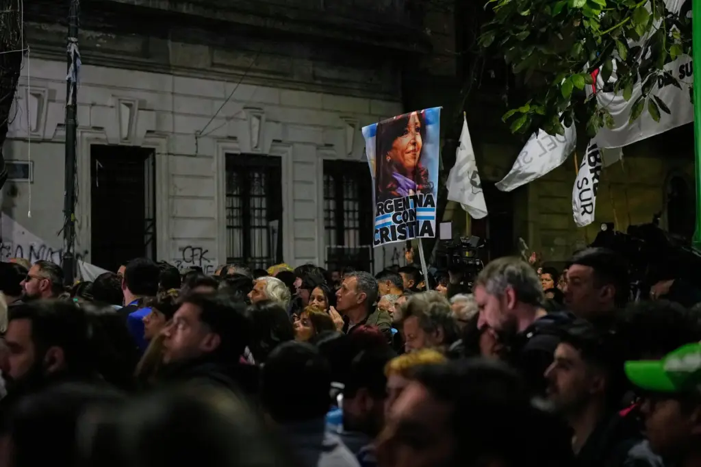 Supporters watch as former Argentine President Cristina Fernandez waves from her balcony.