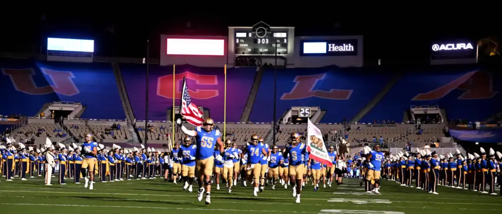 Offensive lineman Hall Schmidt (65) of the UCLA Bruins carries...