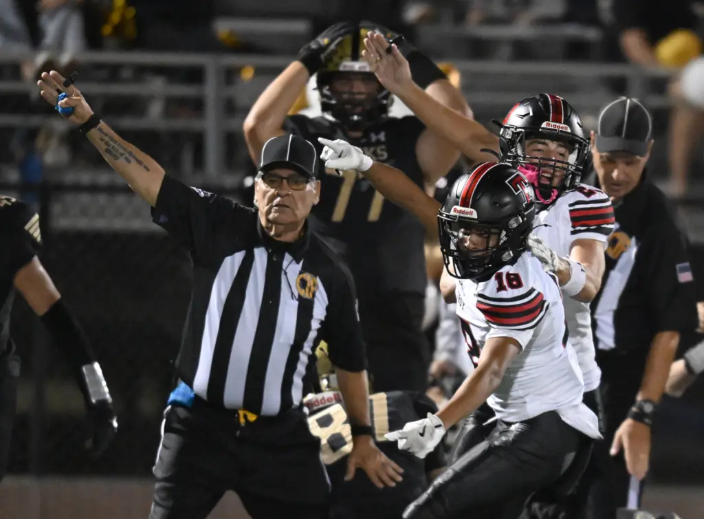 Troy celebrates a fumble recovery in the first half. El...