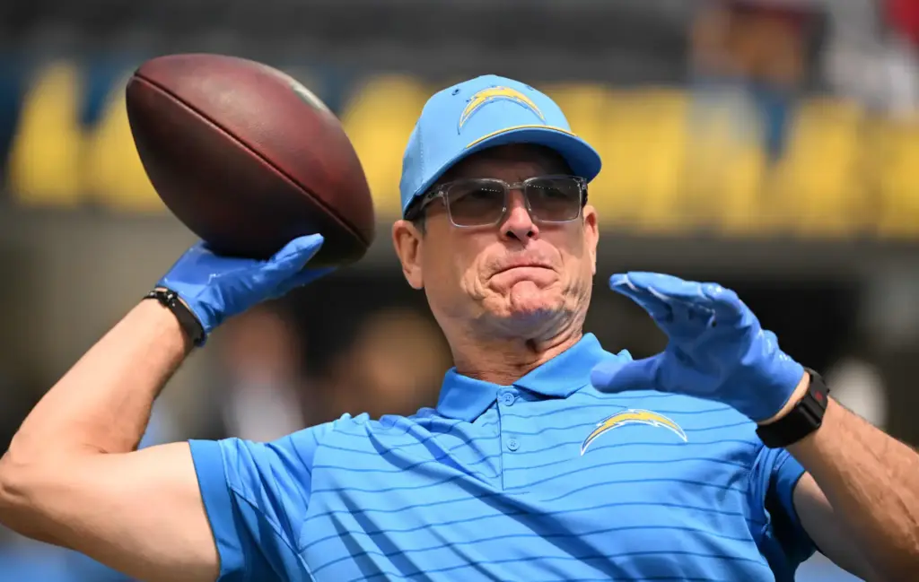 Chargers head coach Jim Harbaugh throws passes prior to an...