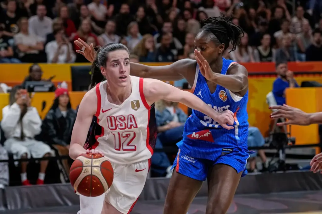 Team USA’s Caitlin Clark drives to the basket as France’s...
