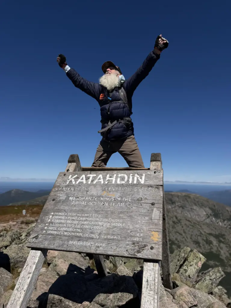 Dale Sanders, 91, celebrates upon completing his hike of the...