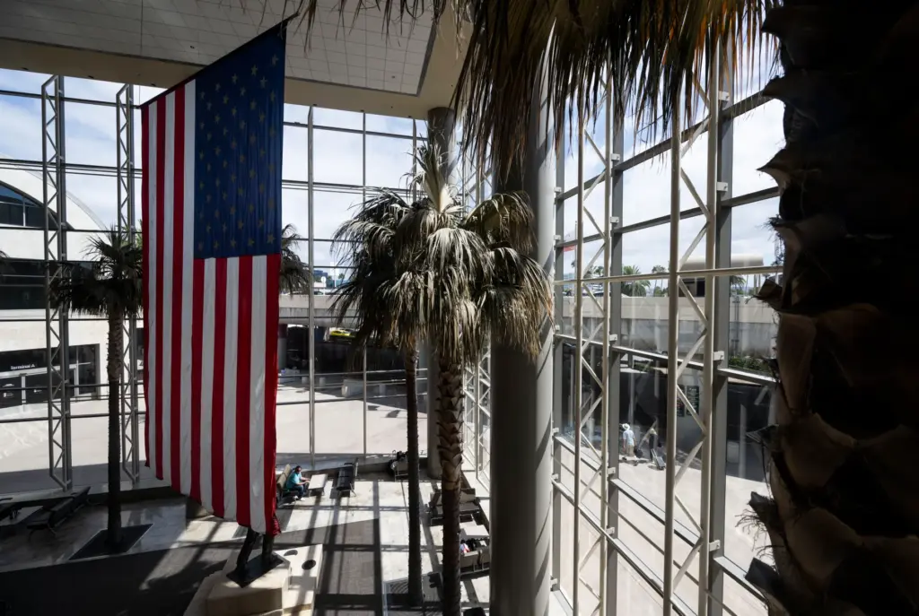 Travelers arrive at John Wayne Airport in Santa Ana on...