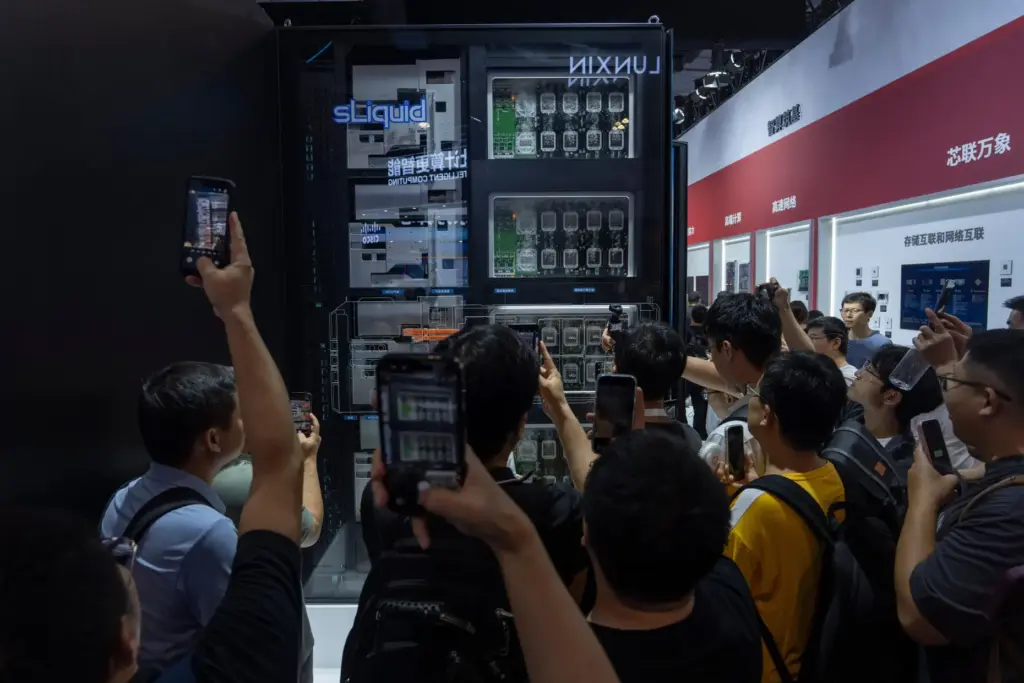 Visitors look at liquid-cooled computer chips.