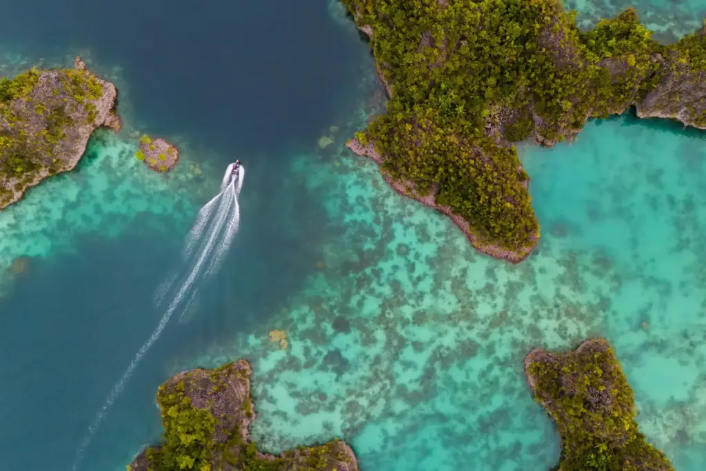 FILE – A speedboat crosses the Waigeo Barat islands, Raja...