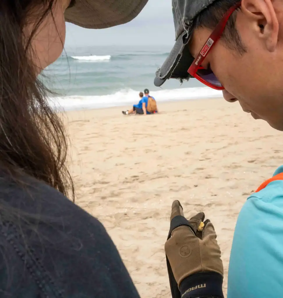 Cassidy Sumague and Eric Heng look at a piece of...