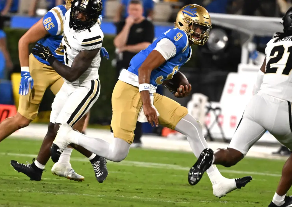 Quarterback Nico Iamaleava (9) of the UCLA Bruins scrambles for...