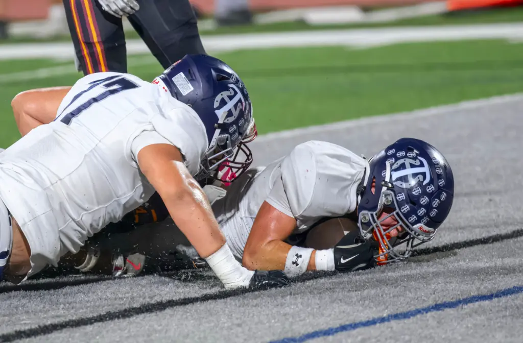 Trabuco Hills running back Luke Hoffman, right, recovers the fumble...
