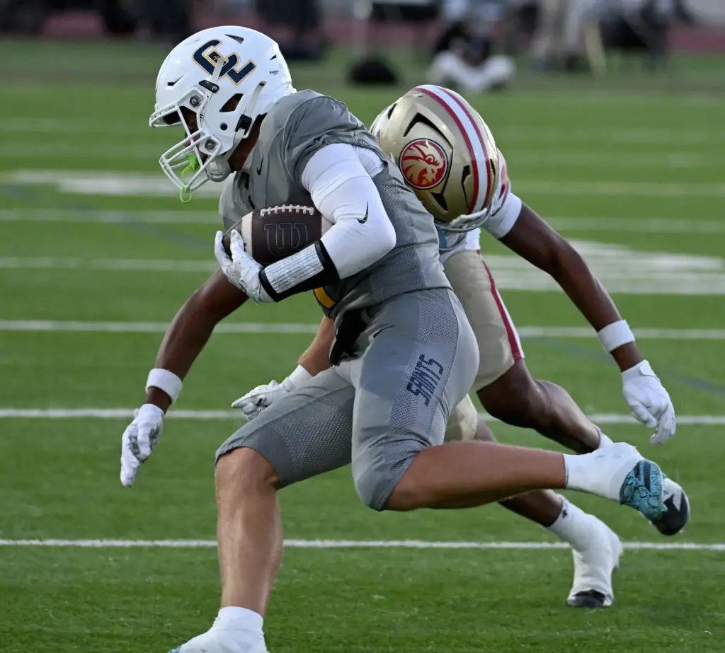 Crean Lutheran’s Troy Roberts (4) runs the ball for a...