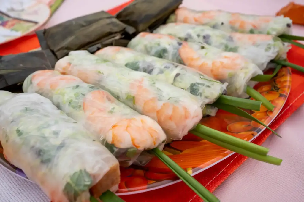 Fresh spring rolls rest together at a table celebrating southern...