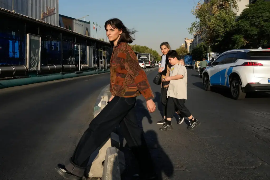 Pedestrians cross the Islamic Revolution street in downtown Tehran, Tuesday,...