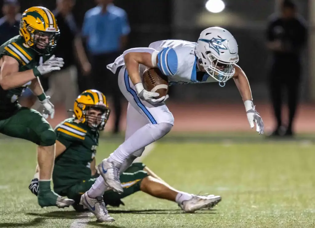 Corona del Mar wide receiver Nolan Scott (8) carries the...