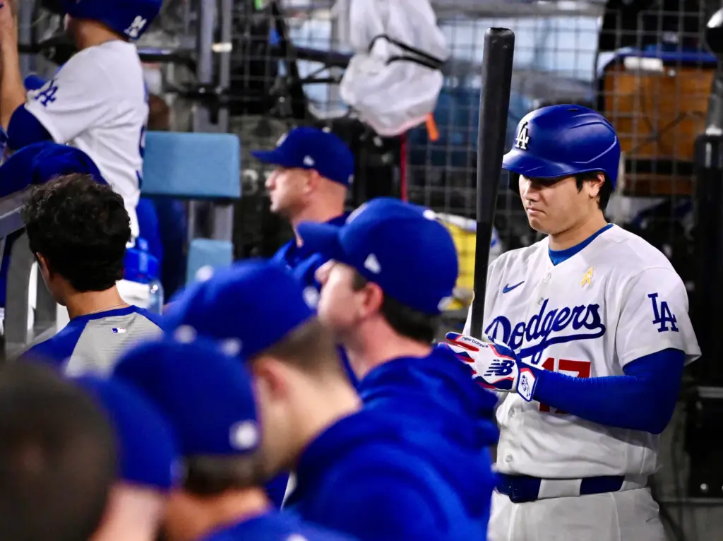 Dodgers star Shohei Ohtani holds a bat during the eighth...