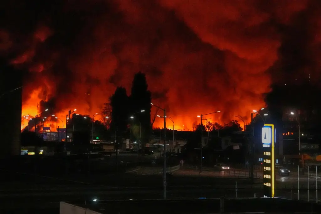 FILE – A fire burns at the book market following...
