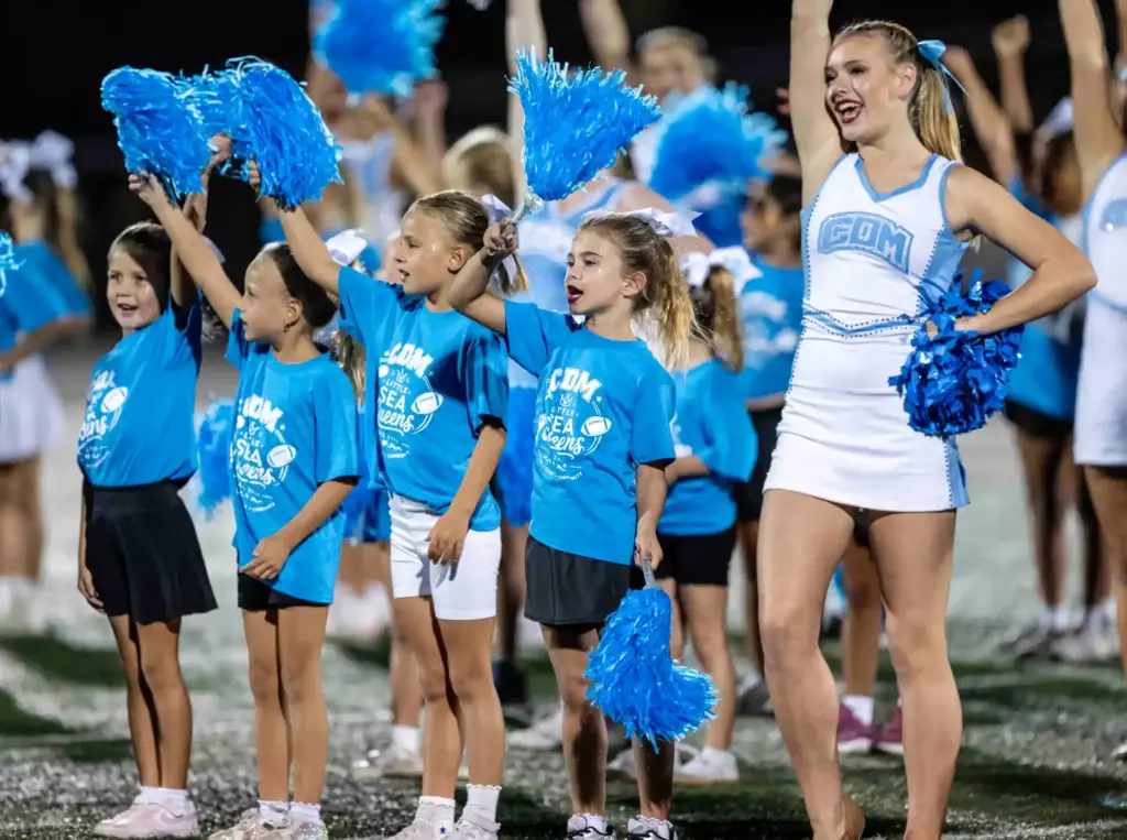 The Little Sea Queens perform with Corona del Mar cheerleaders...
