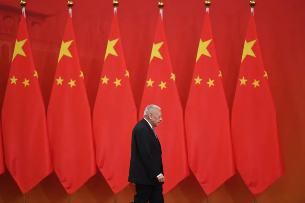 FILE – Former Hong Kong Chief Executive Tung Chee-hwa walks...