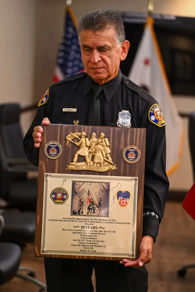 Retired firefighter Fernando Negrete shows a plaque from the 20th...