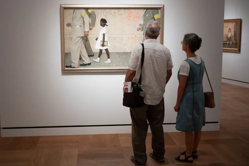 Visitors view a work by Norman Rockwell at the Lucas...