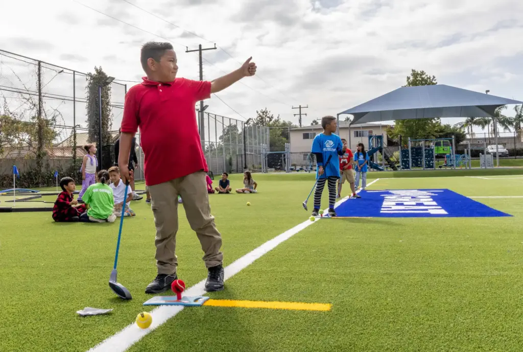 Children practice their golf skills after school at the recently...