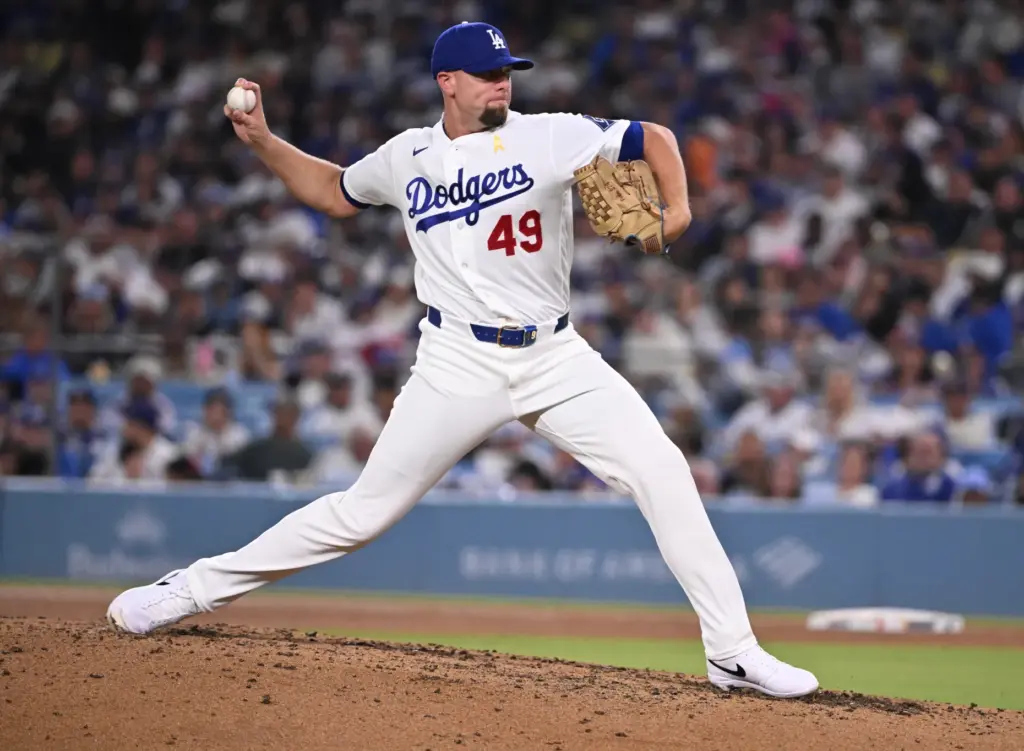 Dodgers relief pitcher Blake Treinen delivers a pitch against the...