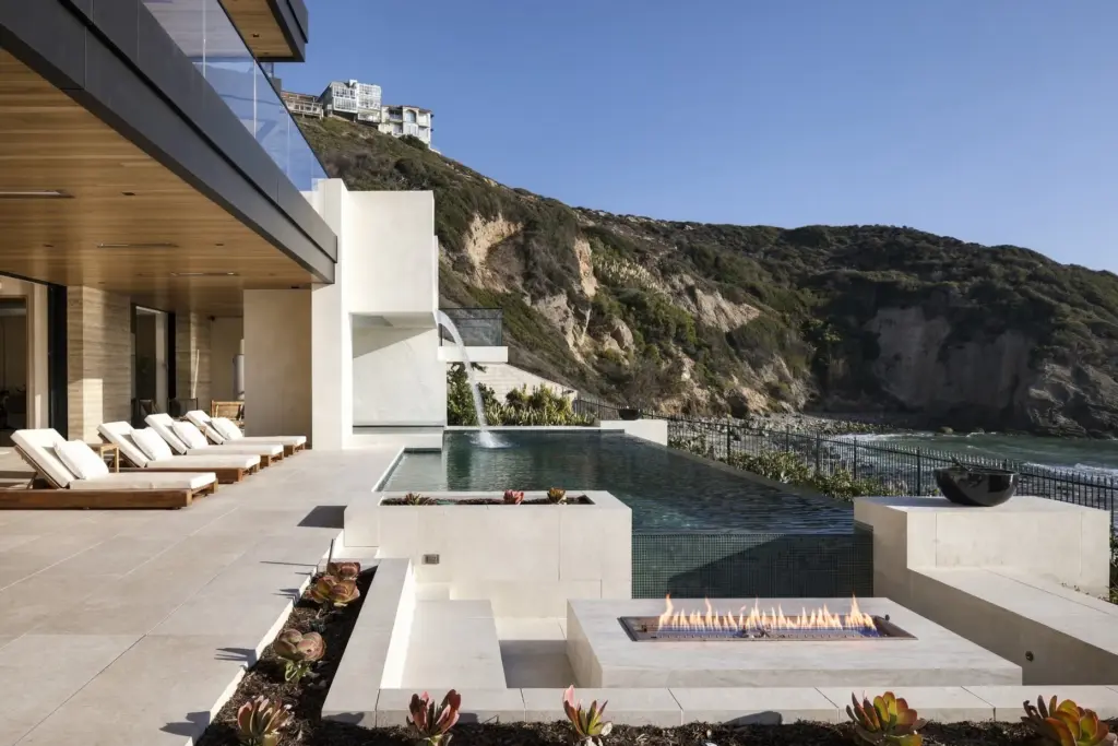 A glass-bottom spa appears to float from the second floor...