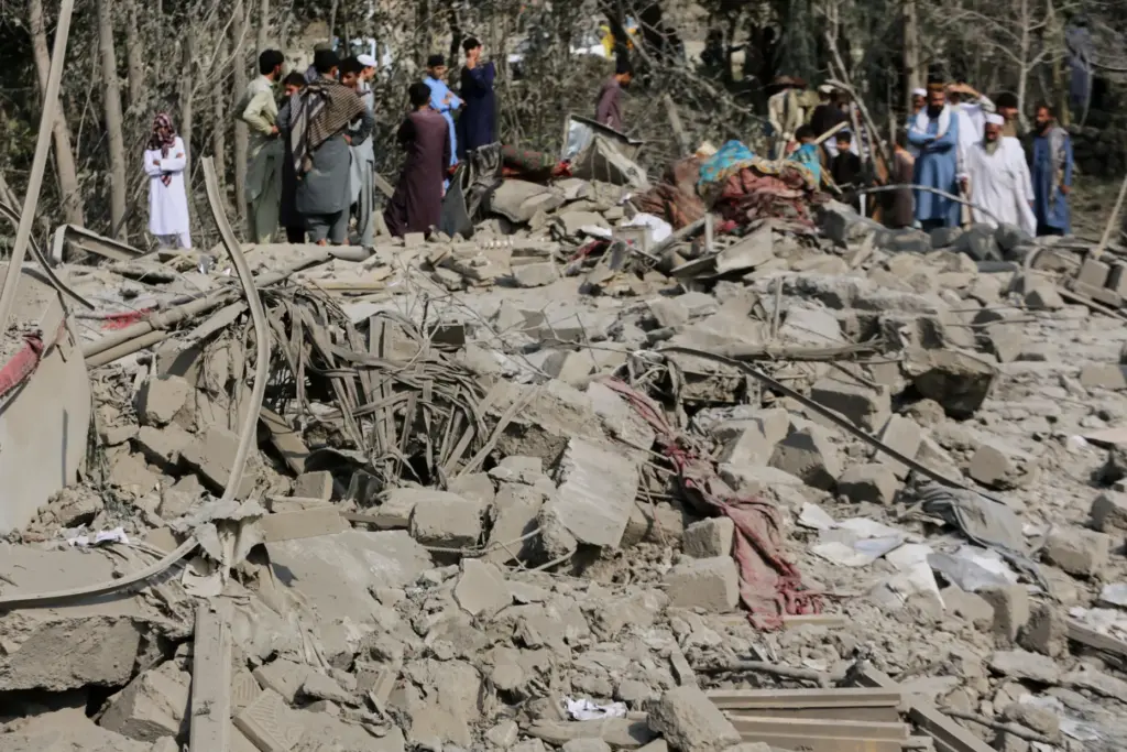 Residents inspect the rubble of a house destroyed in a...