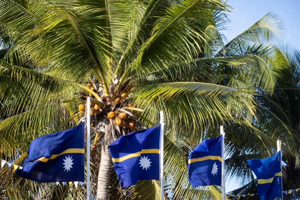 FILE – This shows national flags in Nauru for the...