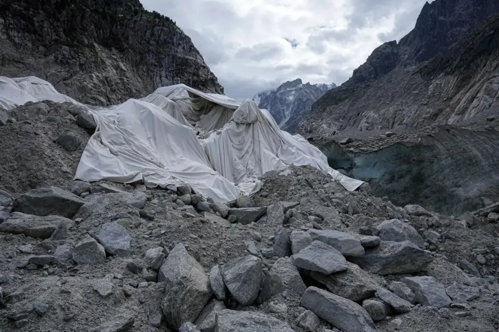 Tarpaulins cover the ice cave of the Mer de Glace glacier to prevent it from melting.