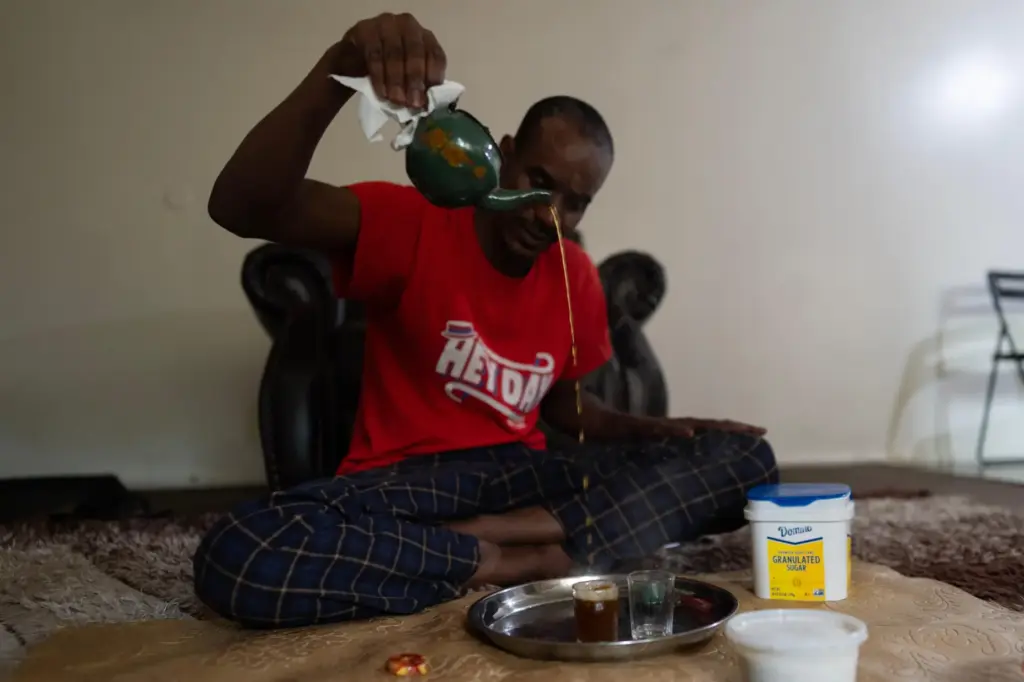 Samba Diallo, a Mauritanian immigrant, makes traditional green tea on...