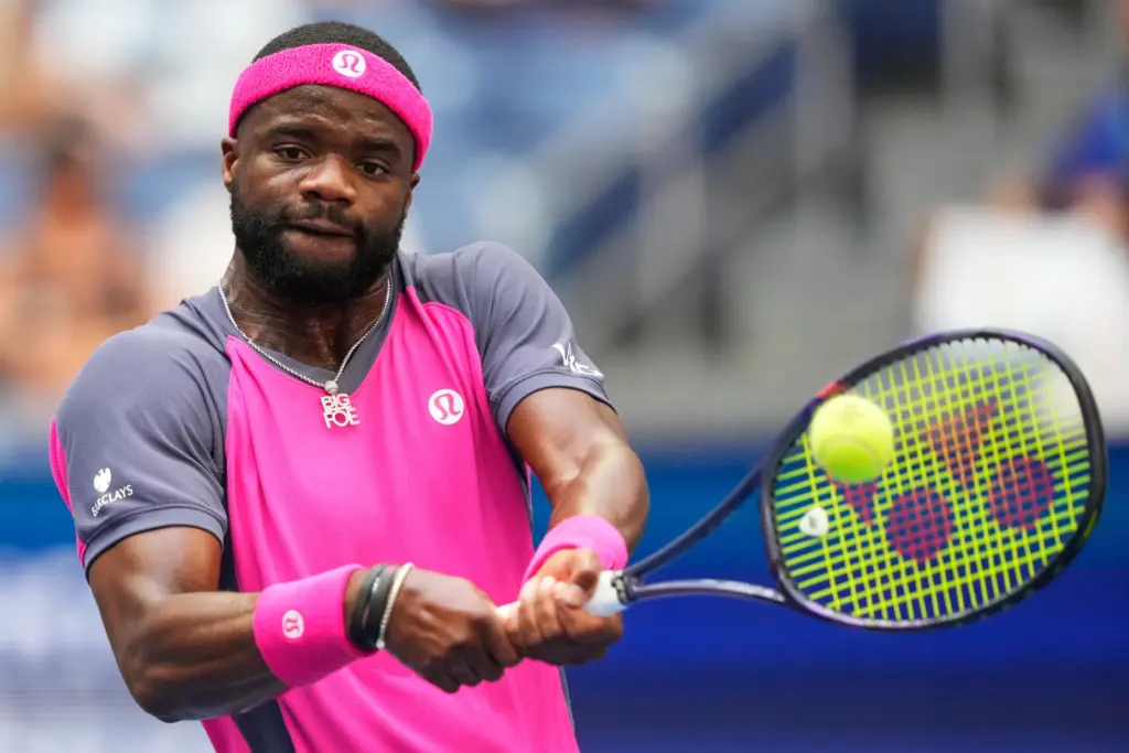 Frances Tiafoe, of the United States, returns the ball to...