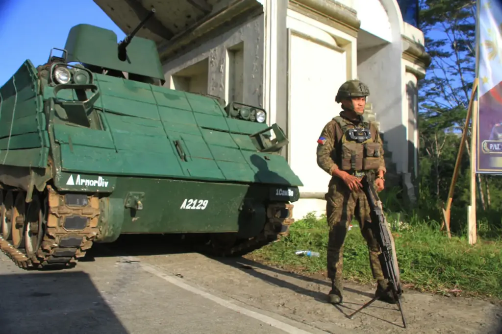 An armored personnel carrier stays at a checkpoint during the...
